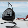 Imperial Double Hanging Egg Chair in Black Wicker Pod with Black Aluminium Frame Front View on Decking with Water